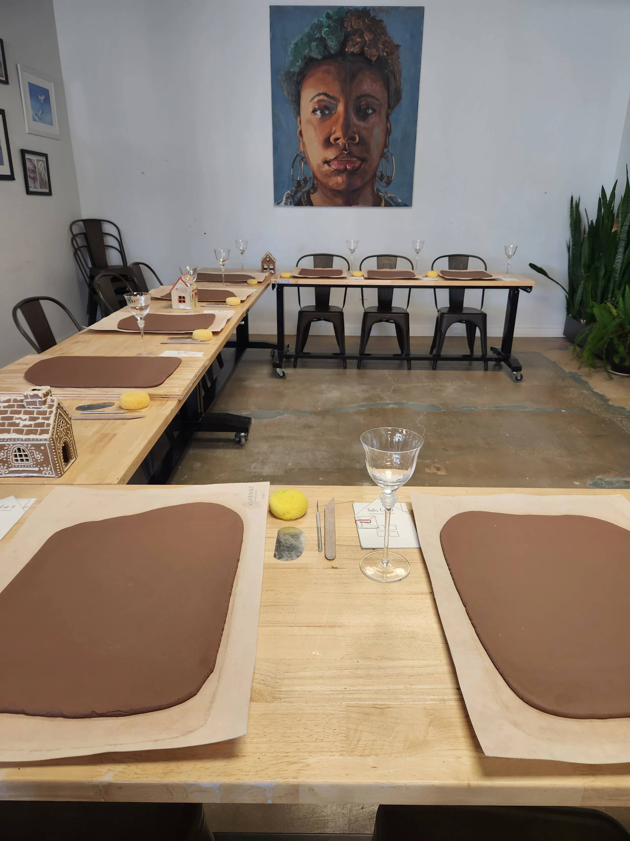 Sip and Sculpt setup with clay and wine glasses at The Art House in St Augustine Beach