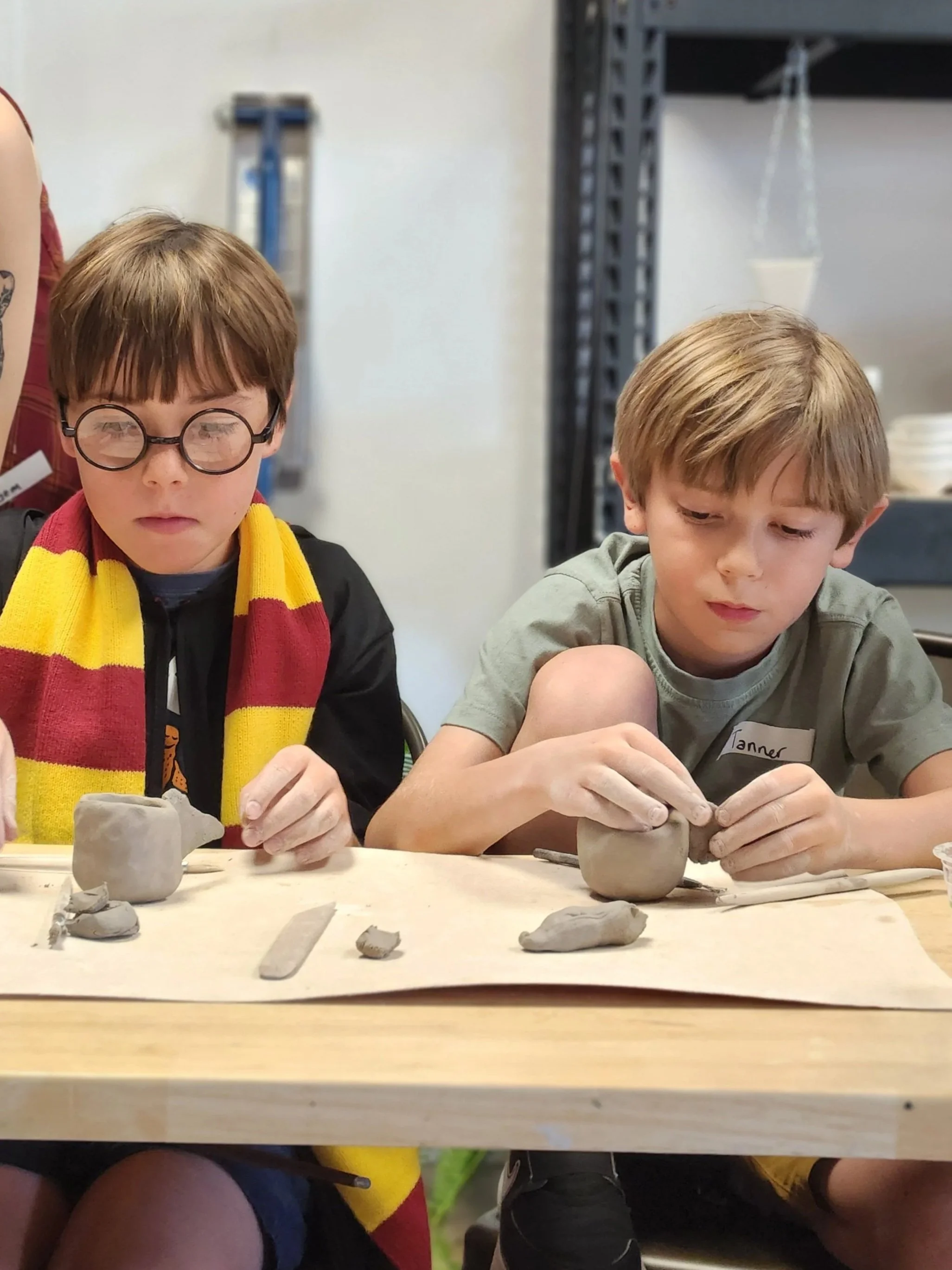 Children participating in a clay hand building class at the art house st augustine