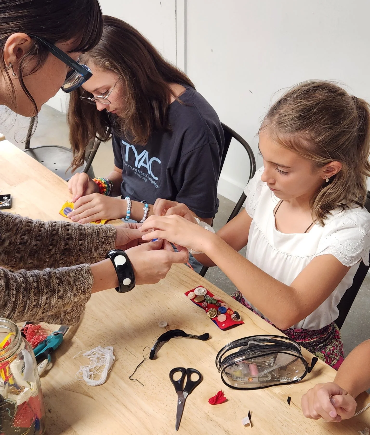 Instructor and student hand sewing class at the art house st augustine