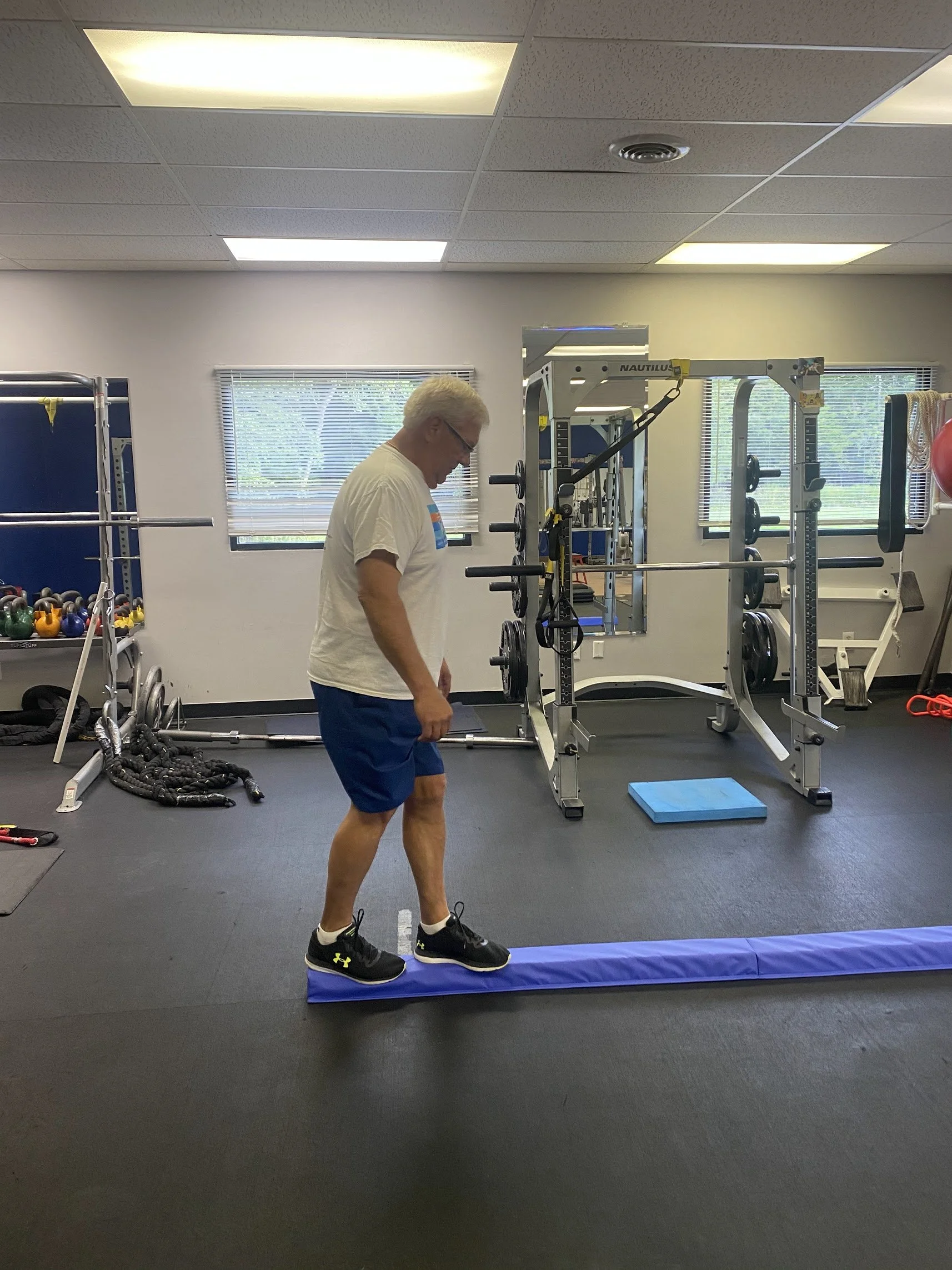 Greg from Bay Village walking. afoam balance beam as he recovers from a knee injury.