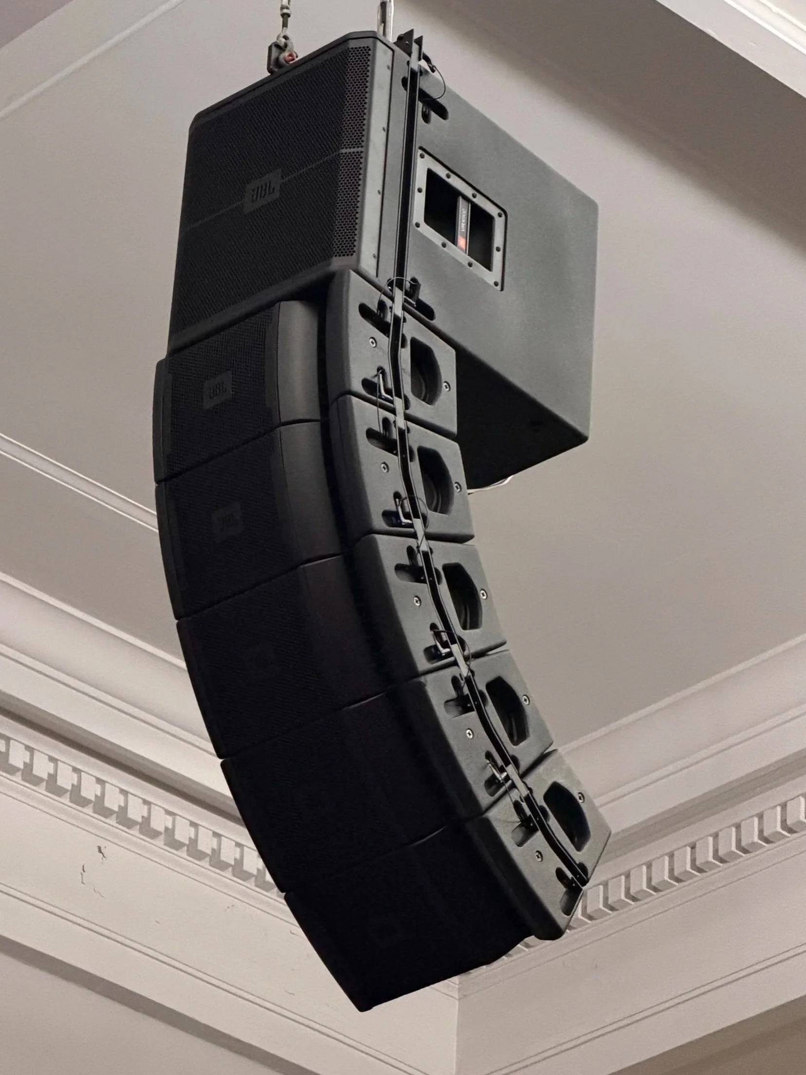 JBL VRX928LA line array elements flown above the stage at Mineola Middle School