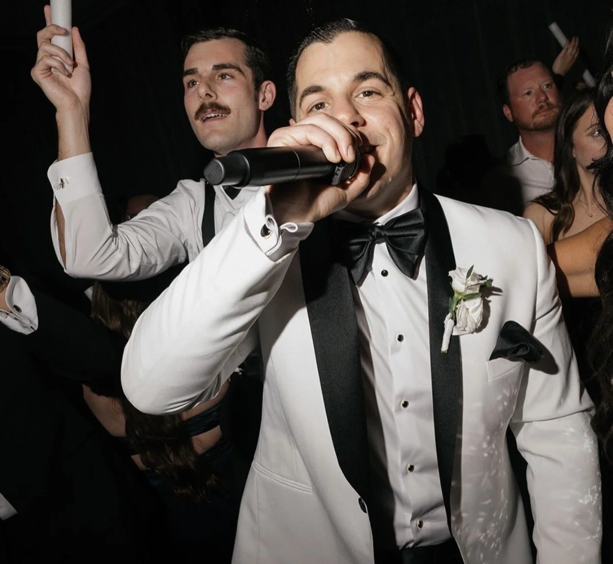 groom steals the mic during his moment on the dancefloor