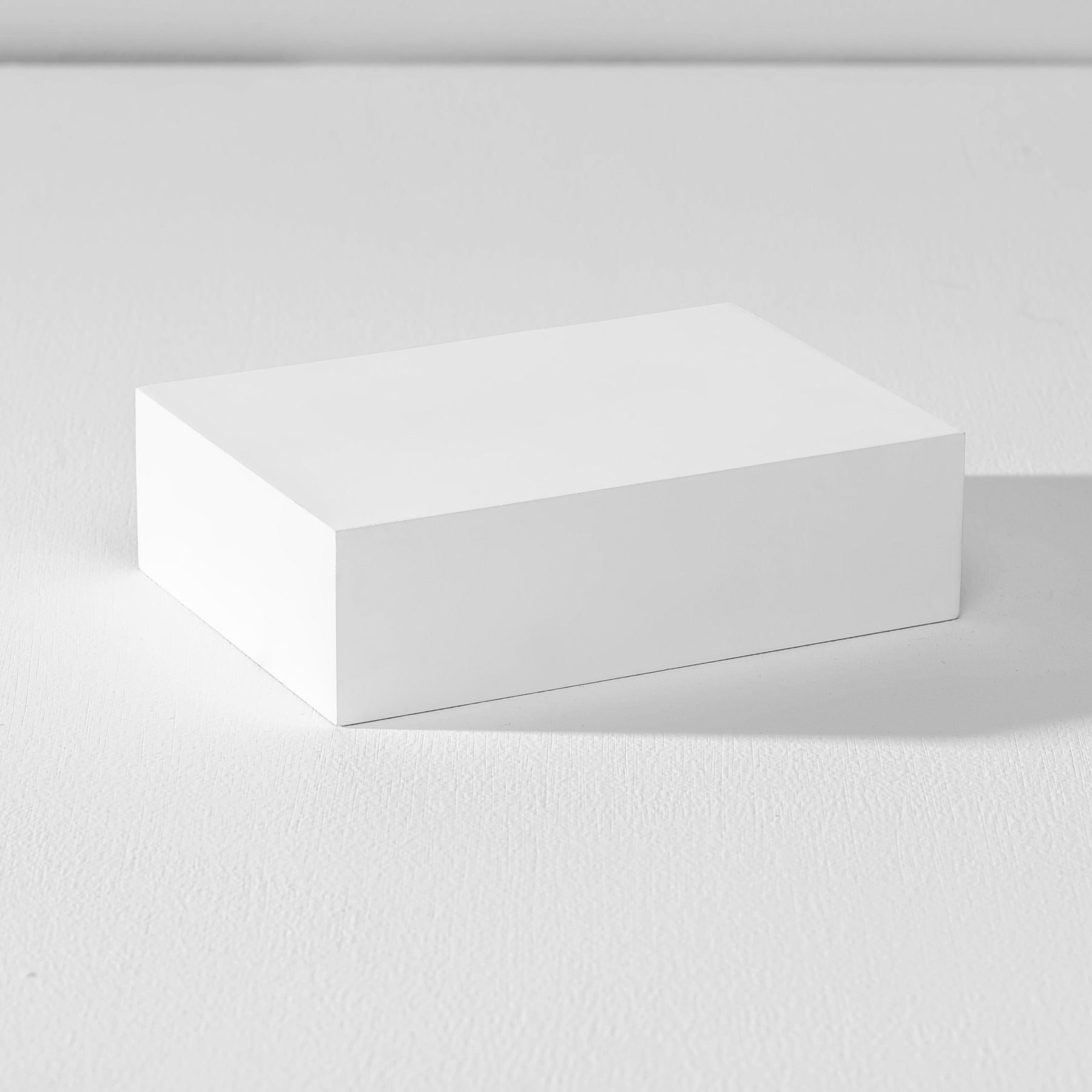 One rectangular white product photography riser on a white background