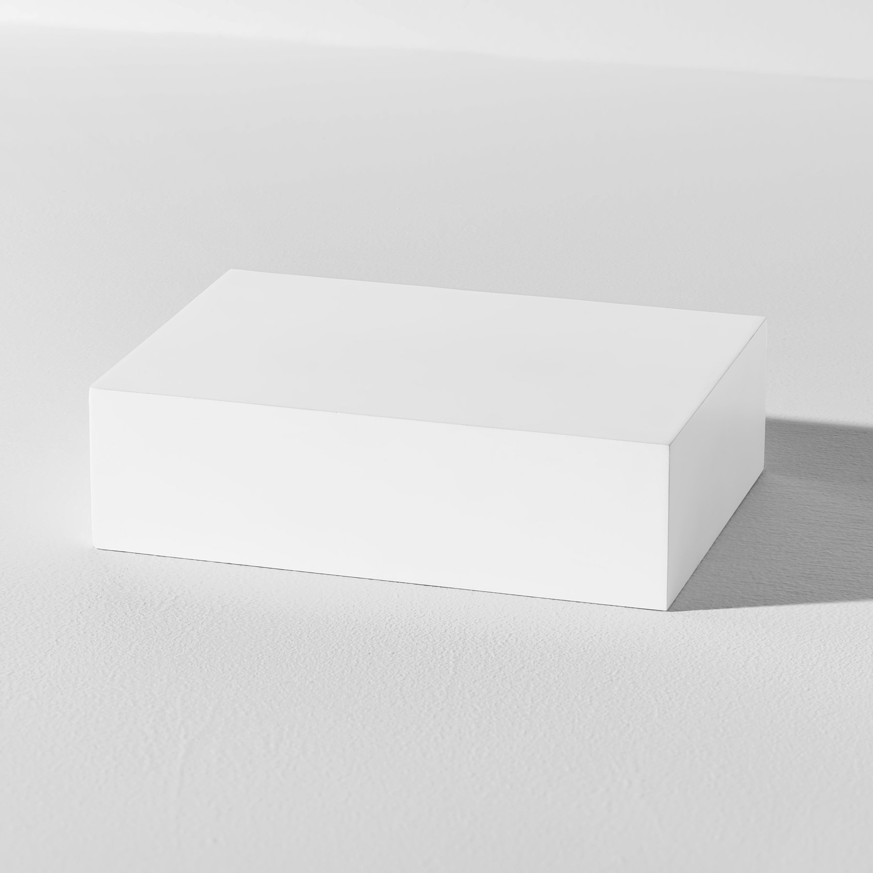 One rectangular white product photography riser on a white background
