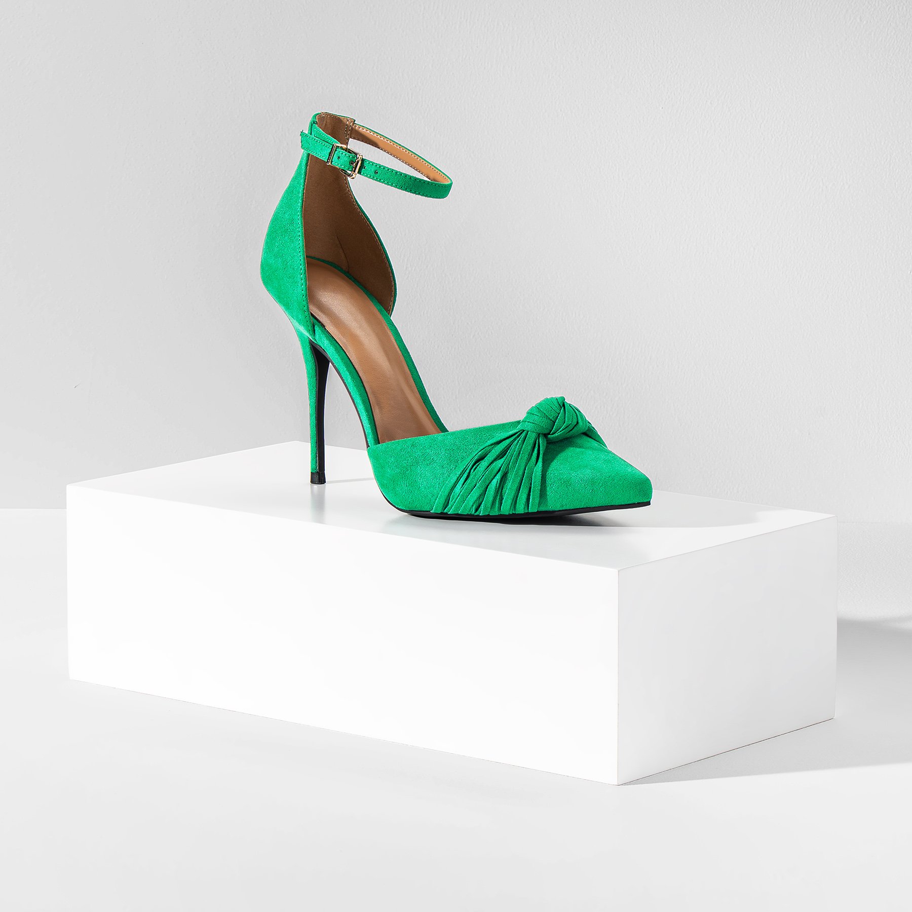 One white product photography box the size of a shoebox, displaying a green high heel shoe on a white background