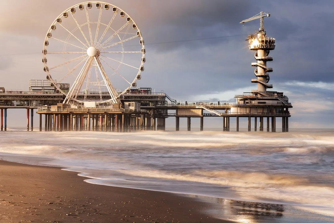 The famous Pier in Scheveningen is an icon on the Dutch coast.
I took this image early in the morning to capture the shimmering sunlight forming from the northeast, casting a golden tint over the coast of Scheveningen. 🎡

Gear: SonyA7riii-Tamron 70-