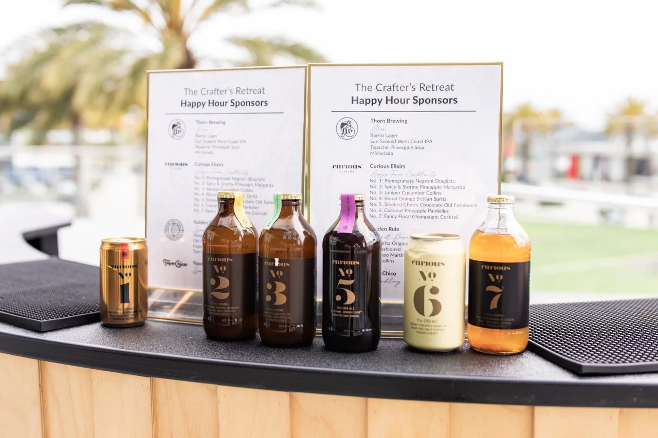 A sponsored bar at a crafting retreat featuring Topo Chico, canned cocktails, and local craft beer