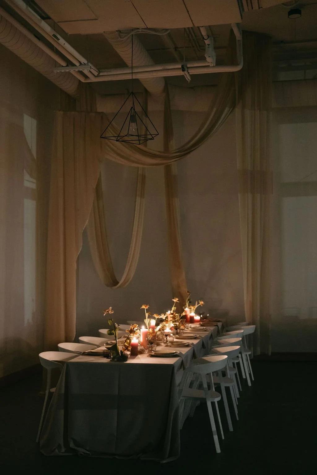 A candlelight table with drapery and florals