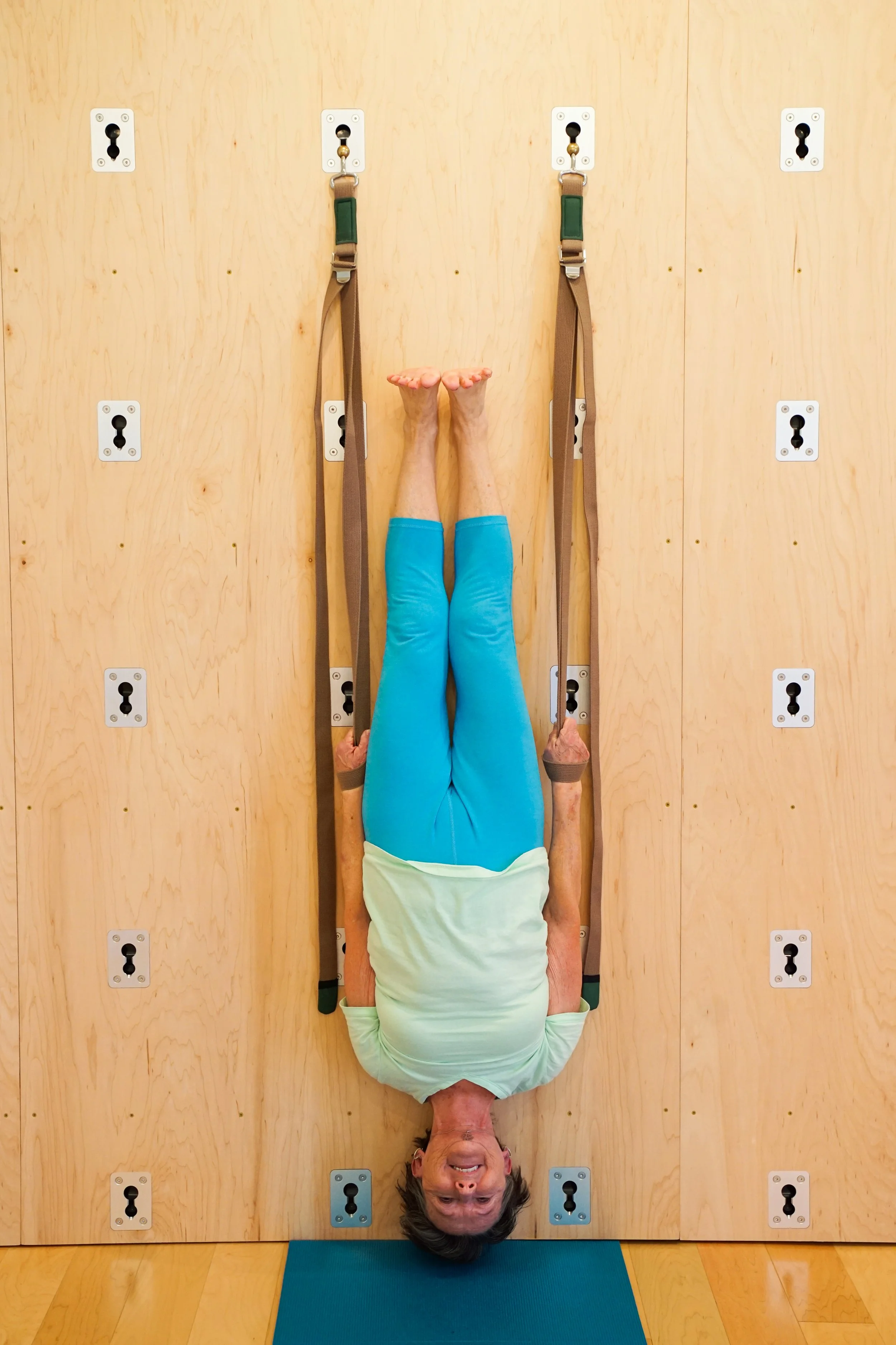Advanced yoga practitioner in a supported full inversion using Great Yoga Wall belts during Level 2 training in Asheville, NC