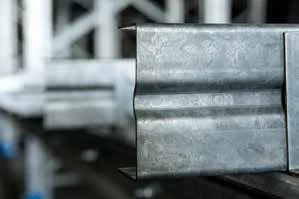 Close-up of a metal rail or track in an industrial setting.