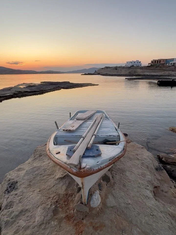 Milos, where the air drips honey, soft and sweet,
Where lava cliffs and turquoise waters meet.
Boats drift on the breeze like a gentle sigh,
As cave mouths open wide to greet the sky.

The wind moves slow, warm as a loving word,
While the sparrows so