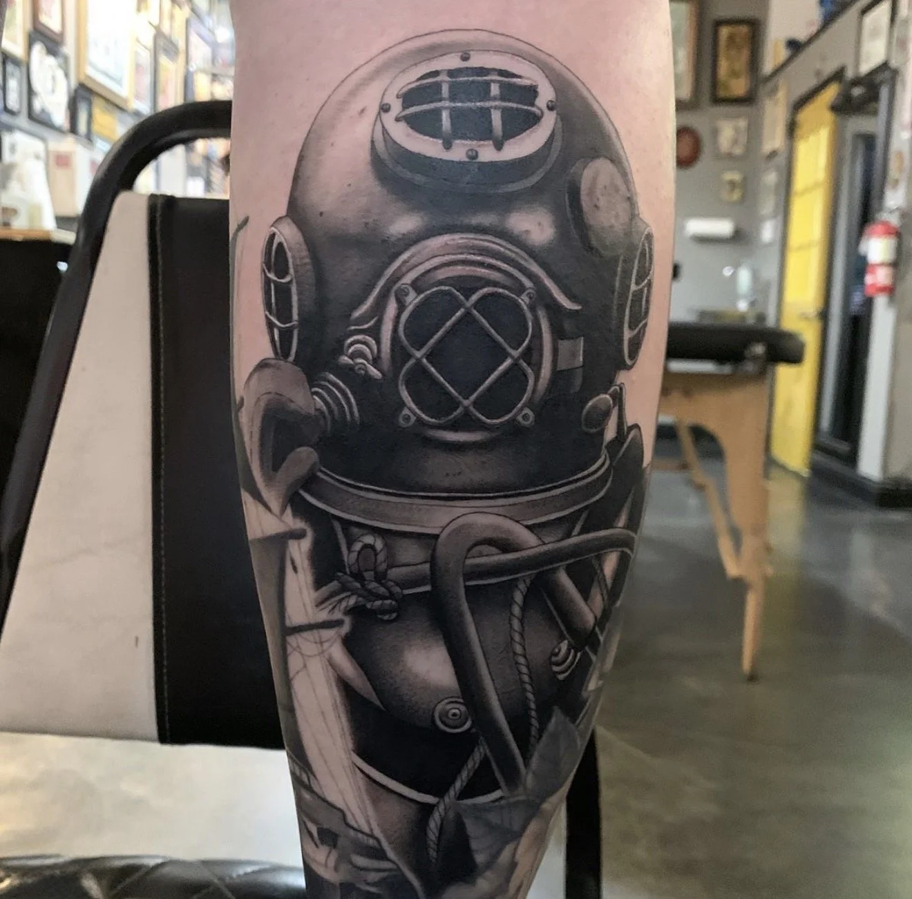Black and gray tattoo of a vintage deep-sea diving helmet on a person's arm in the best tattoo parlor in carson city nv
