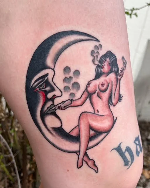 Tattoo of a woman with dark hair sitting on a crescent moon, smoking, with a face that has a sad expression.