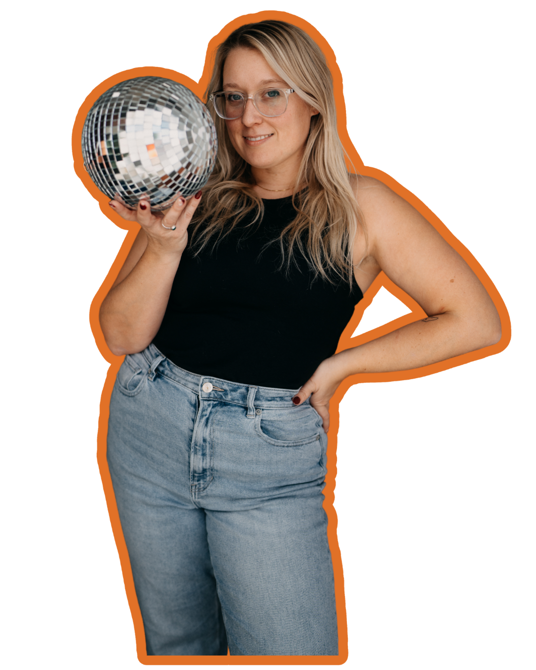 A woman with blonde hair, glasses, and wearing a black sleeveless top and jeans, holding a disco ball and smiling at the camera.
