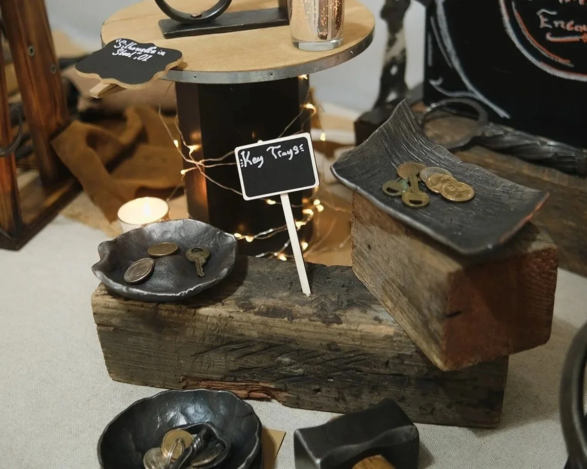 custom key trays sitting on a table at an in person event. We make custom designs in metal key trays.