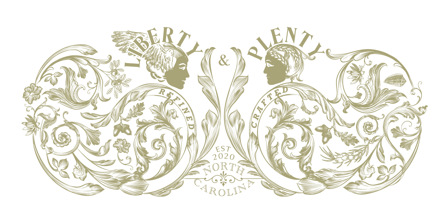 Decorative logo with two female profiles facing each other, surrounded by floral and swirling patterns. Text reads "Liberty & Plentyt," "Handcrafted," "Established 2020," "North Carolina."