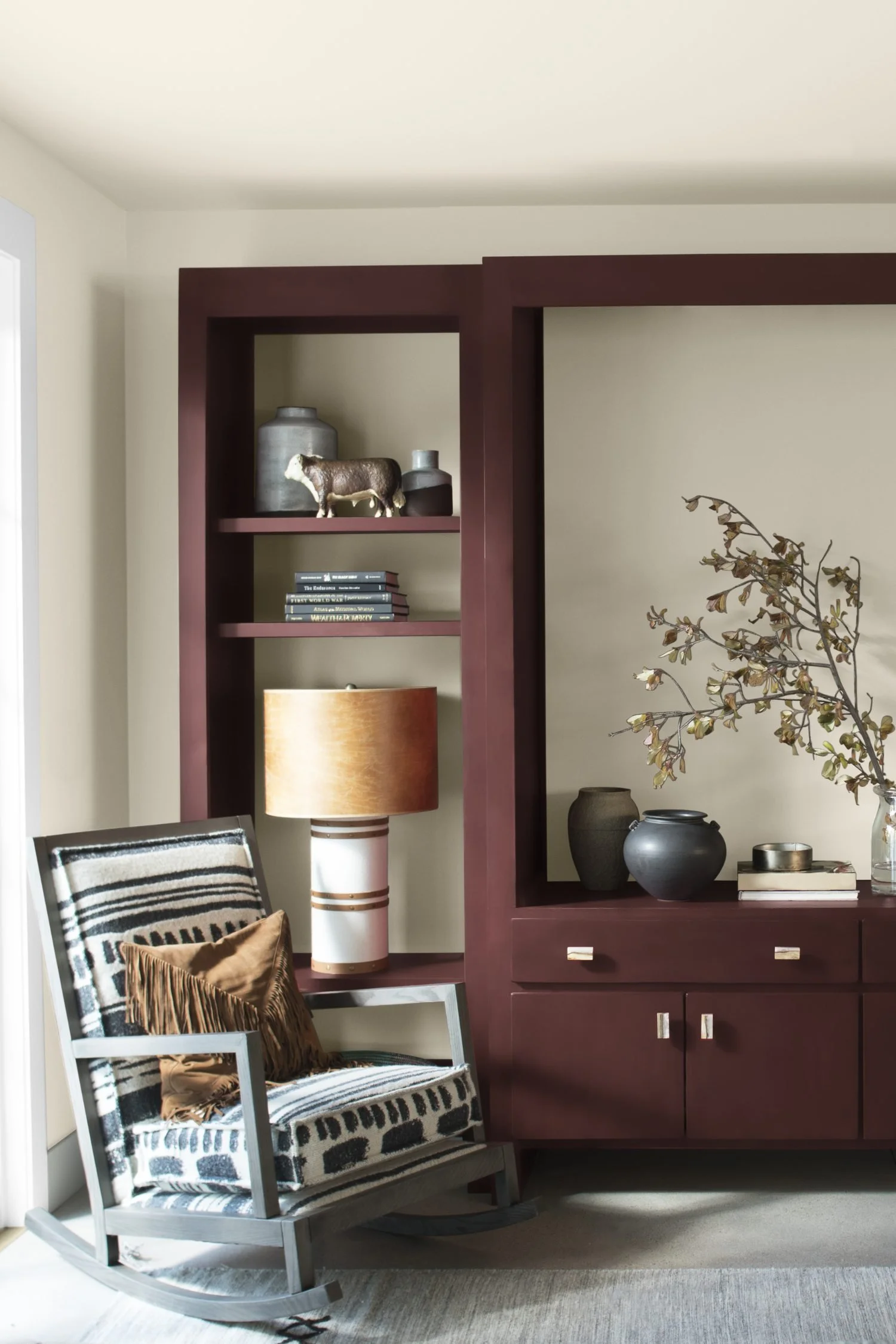 Built-in cabinetry painted in Benjamin Moore New London Burgundy, creating a rich deep red feature against lighter walls.