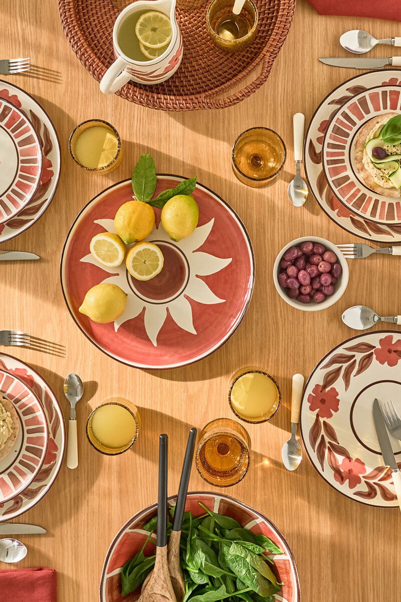 Mediterranean-inspired stoneware tableware in warm terracotta tones with graphic patterns.