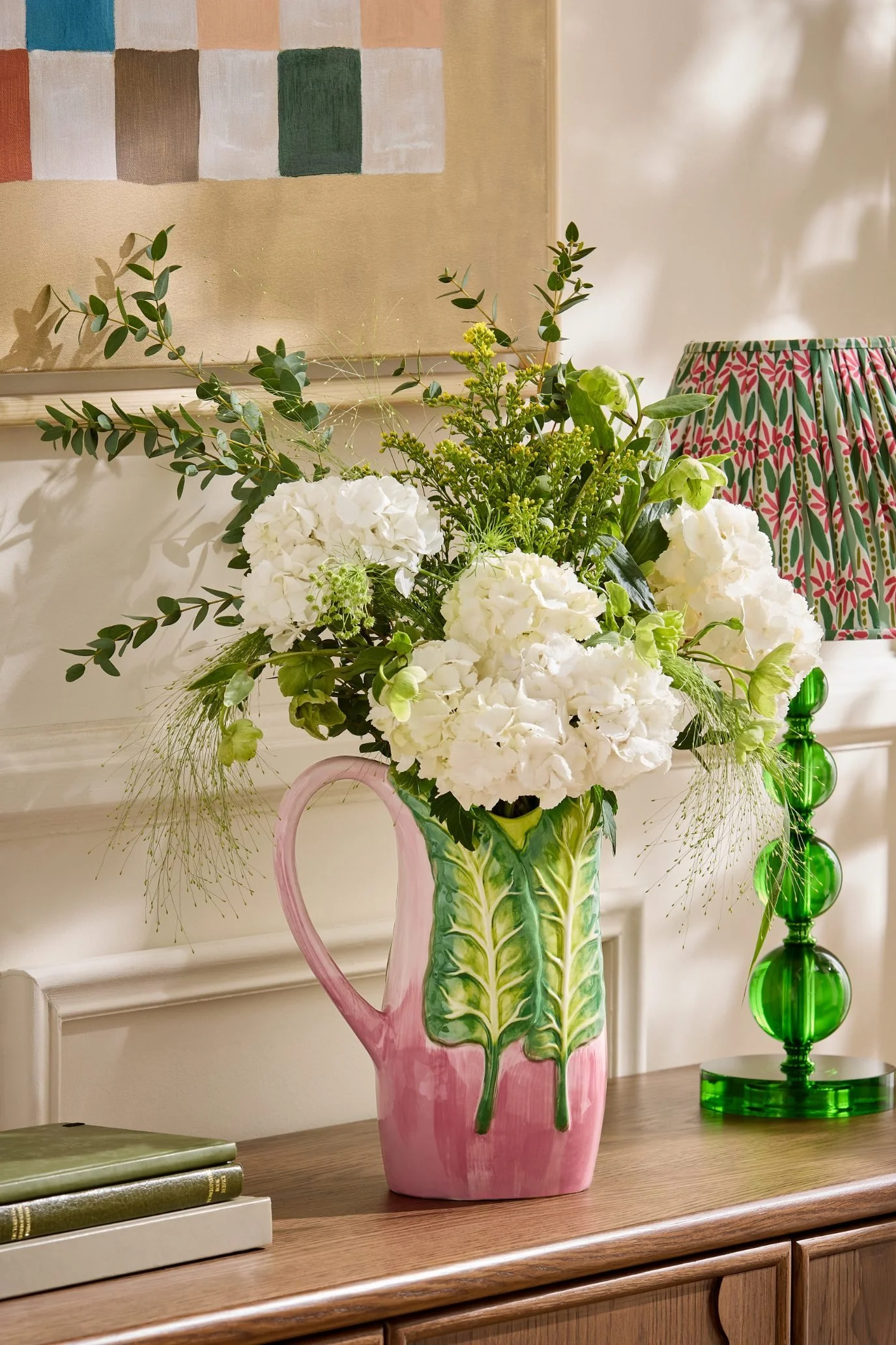 Pink glazed jug vase with hand-painted green Swiss chard leaves and flowers.