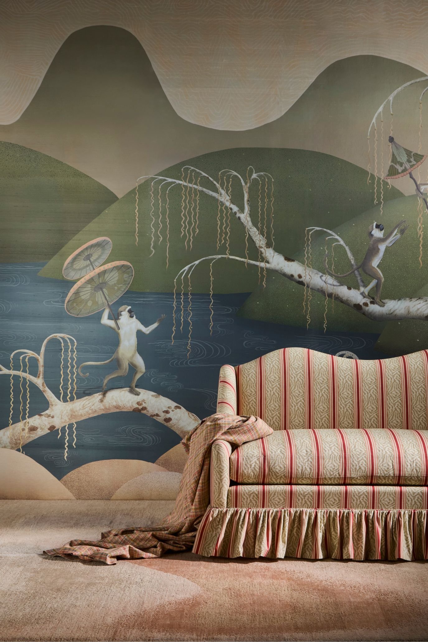 Seaside Singerie wallcovering at Design Centre Chelsea Harbour, styled with a striped skirted sofa and soft layered textiles.