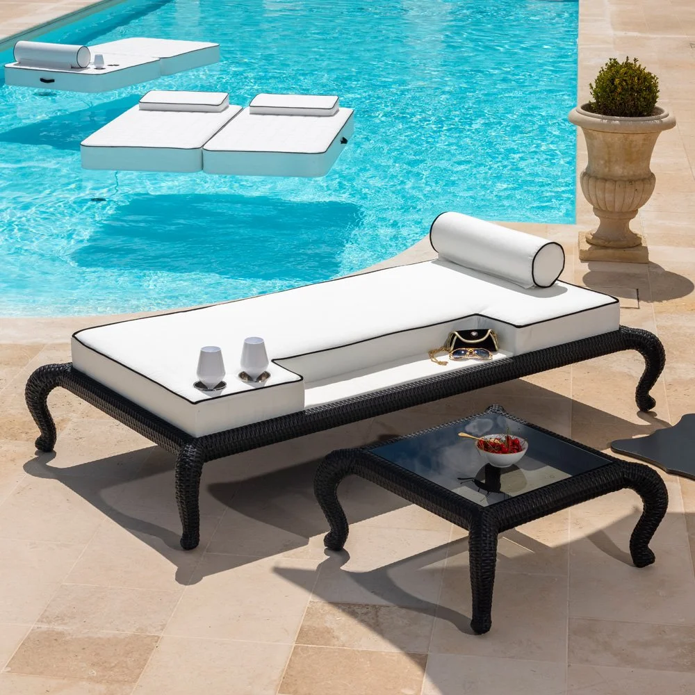 luxury outdoor daybed in black with white cushions next to a pool