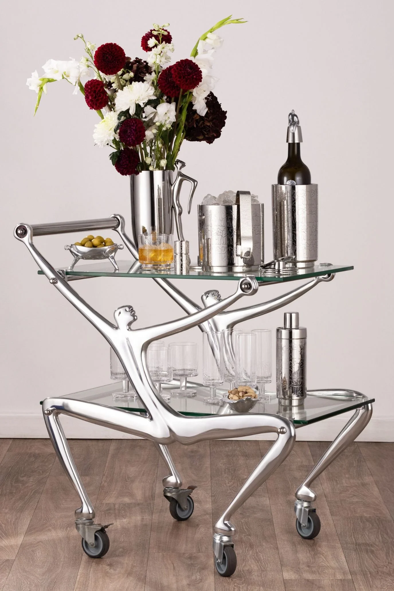 Sculptural bar cart in the shape of a man with bottles and glassware