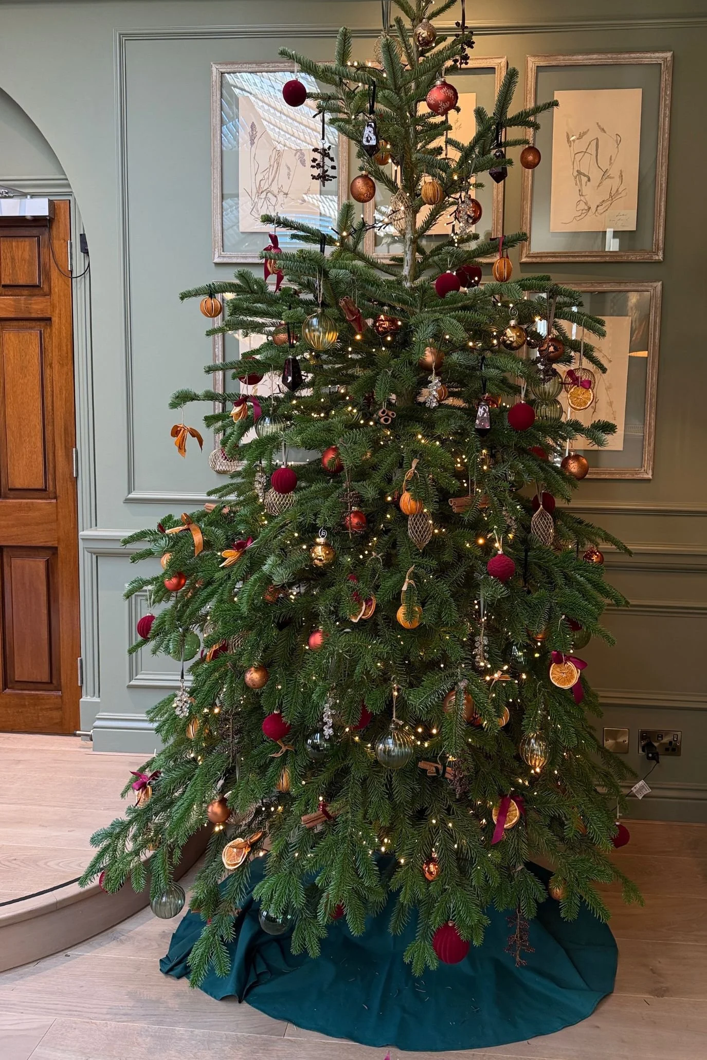 a traditional christmas tree with citrus and cinnamon decorations