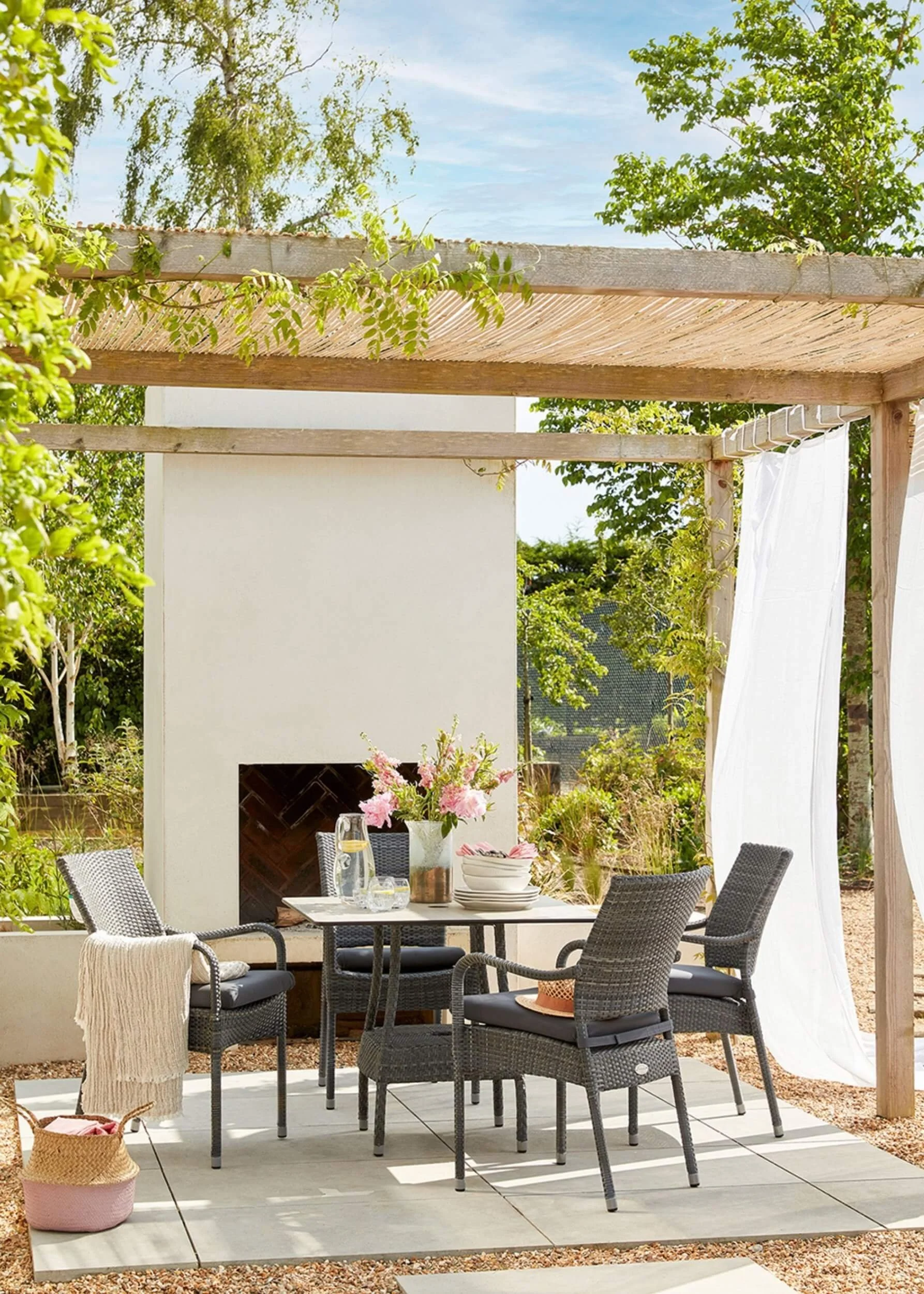 Stylish outdoor pergola with outdoor chimney and white voile curtains