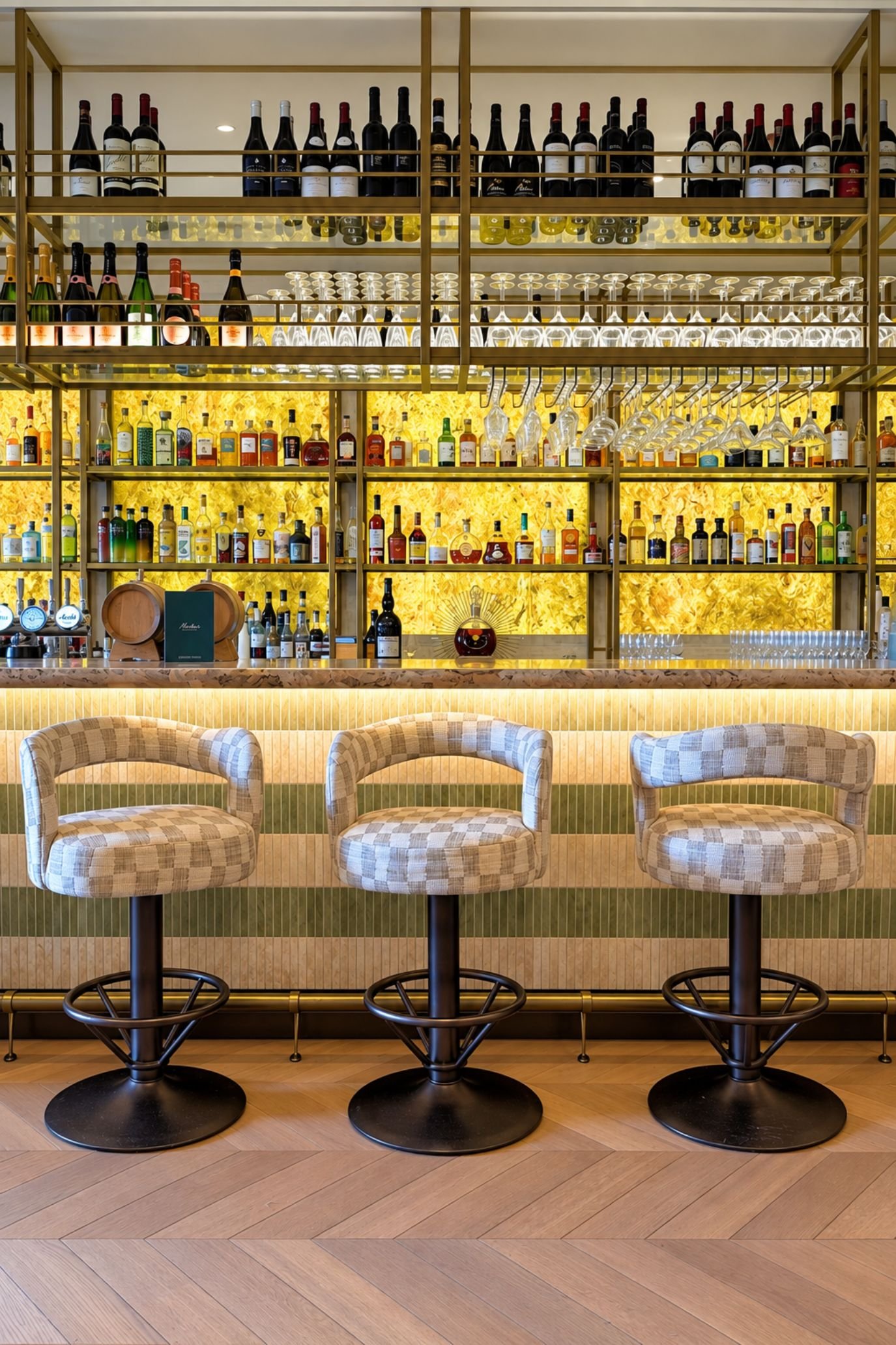 Stylish hotel bar interior with bottles, glassware and ambient lighting