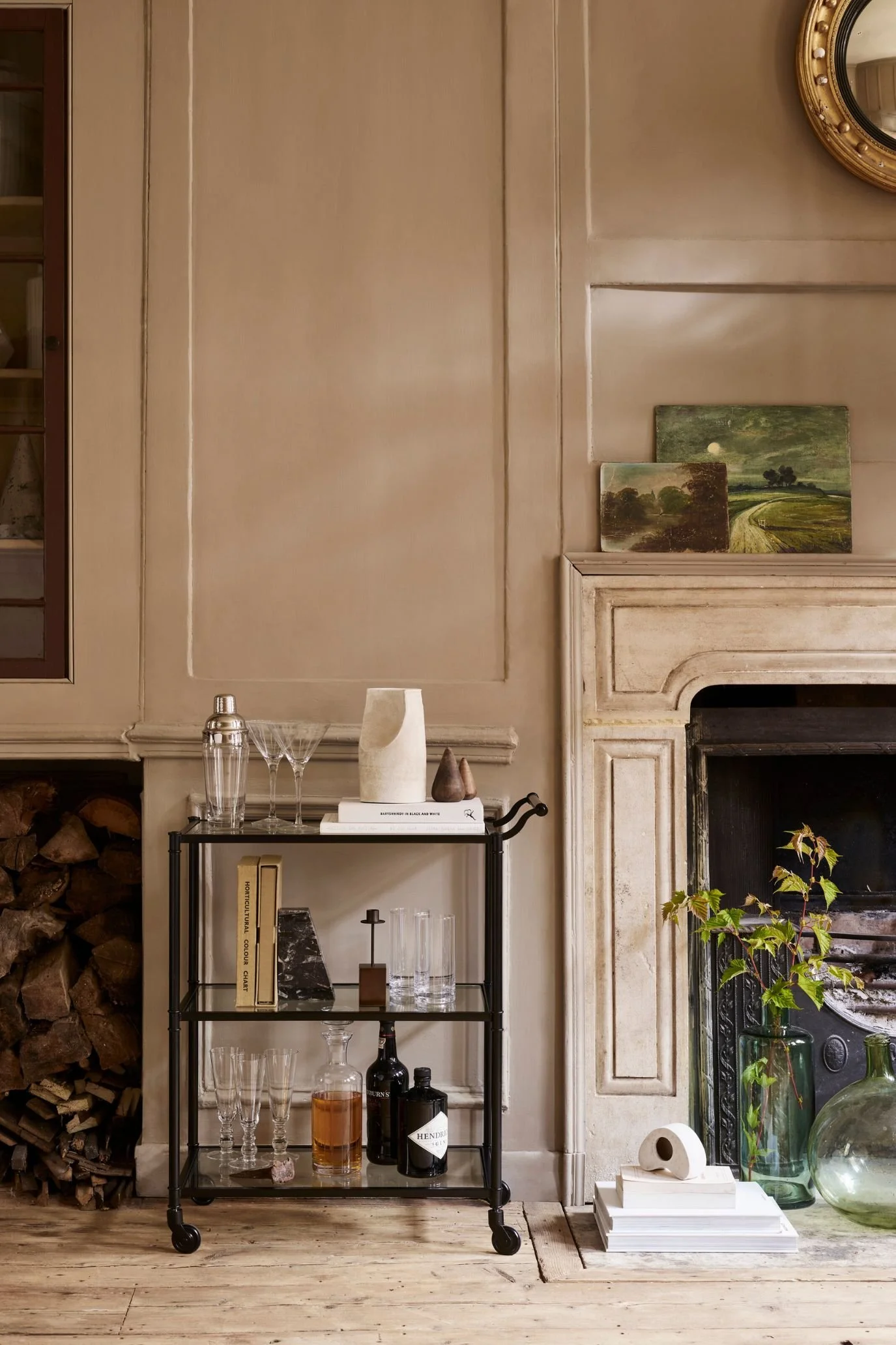 Black bar cart with bottles and cocktail glassware