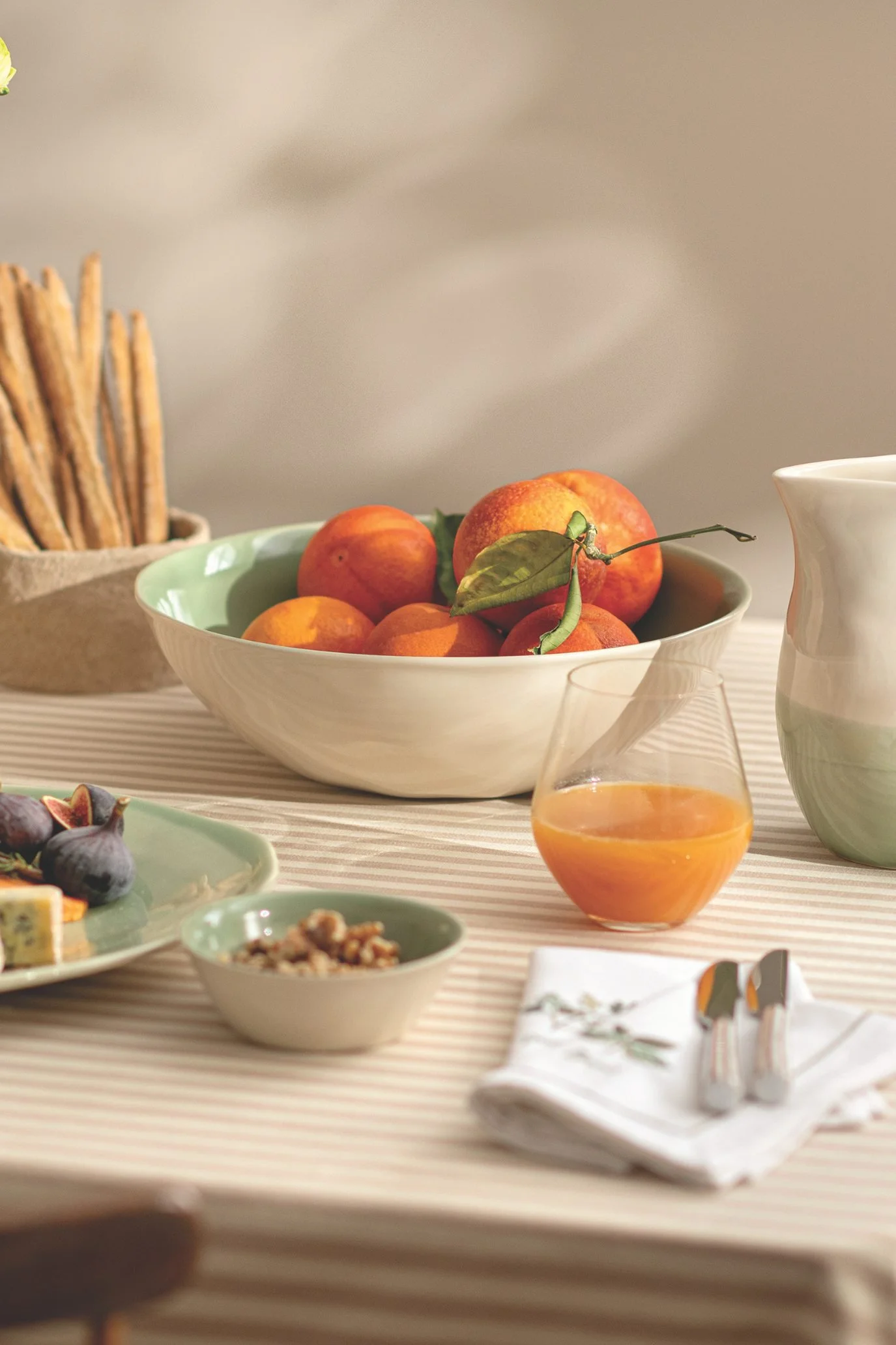 Soft green reactive glazed stoneware serving bowls and platters for summer entertaining.