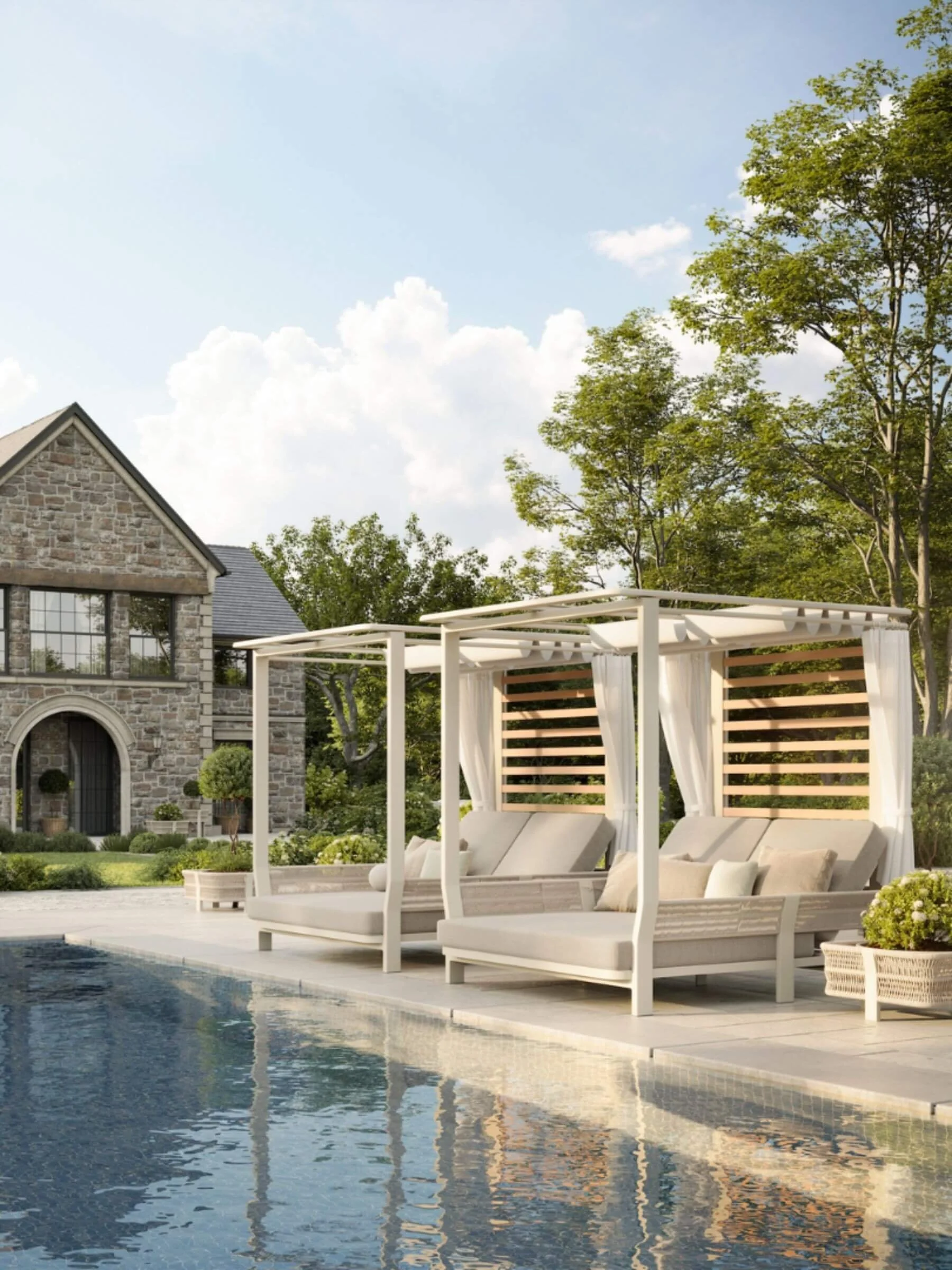 Two outdoor pergola daybeds with curtains and cushions next to a pool