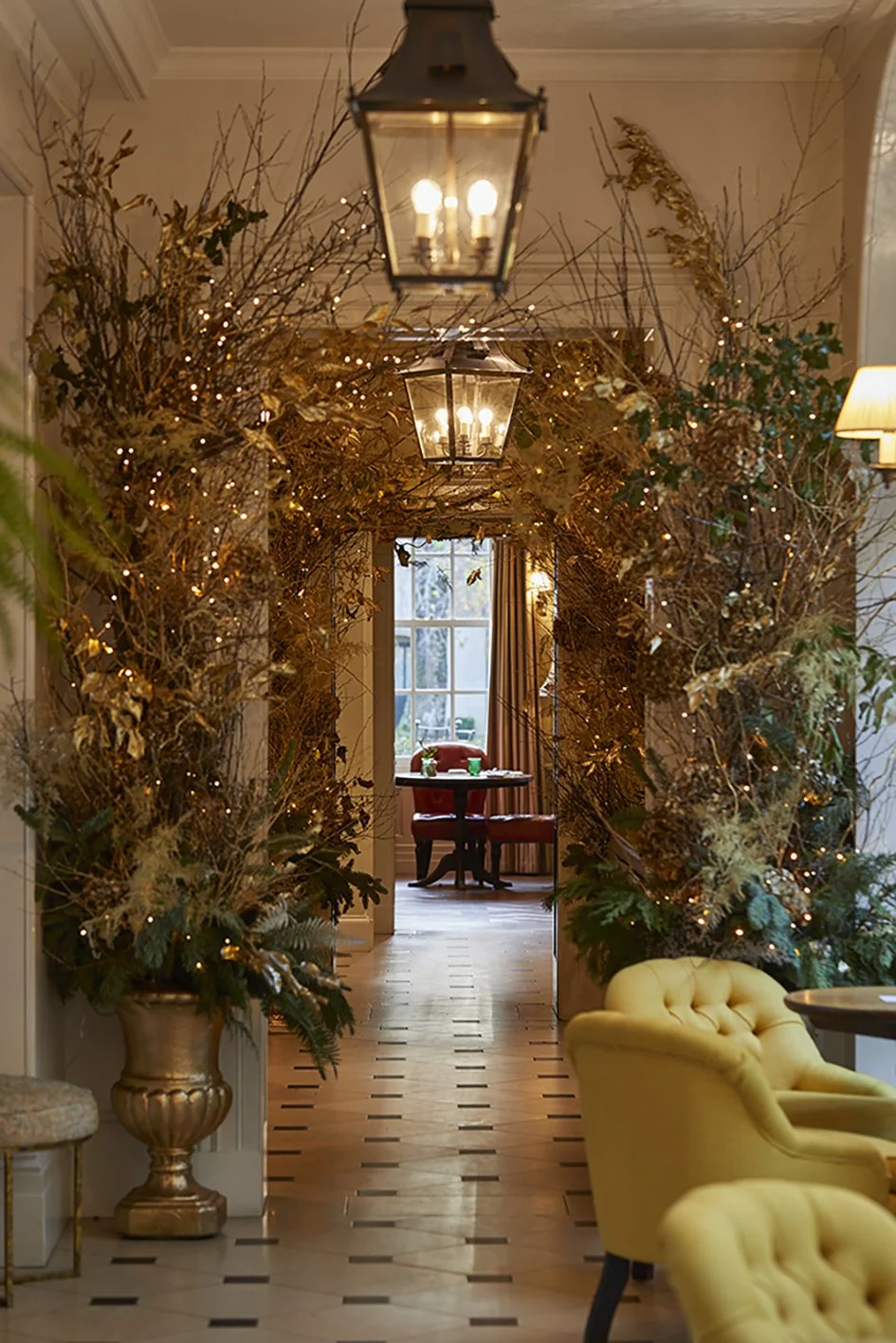 Dried leaves and Christmas decorations from pots around the wall to form an arch