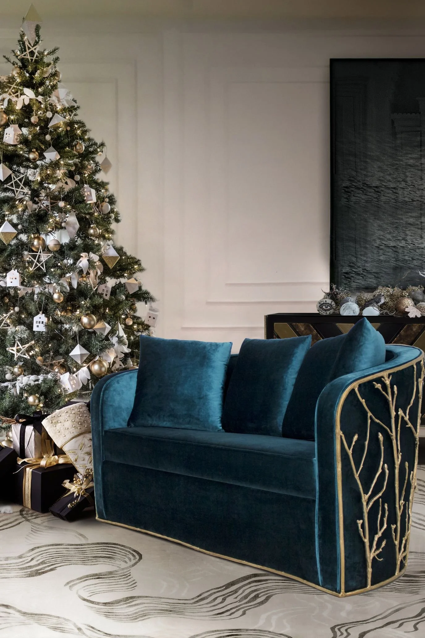 Christmas tree decorated with miniature white houses, stars and geometric ornaments beside a teal velvet sofa.