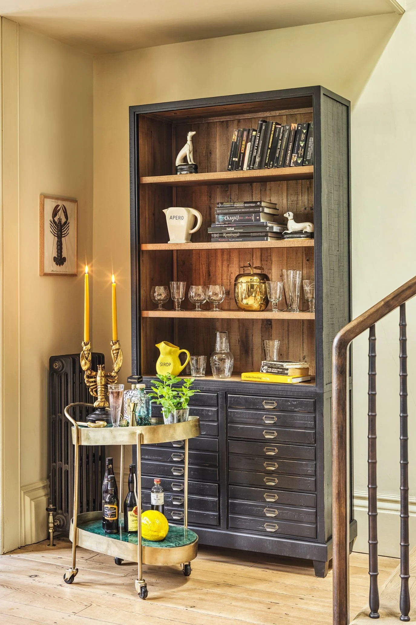 Drinks trolley positioned in front of fitted bar cabinetry