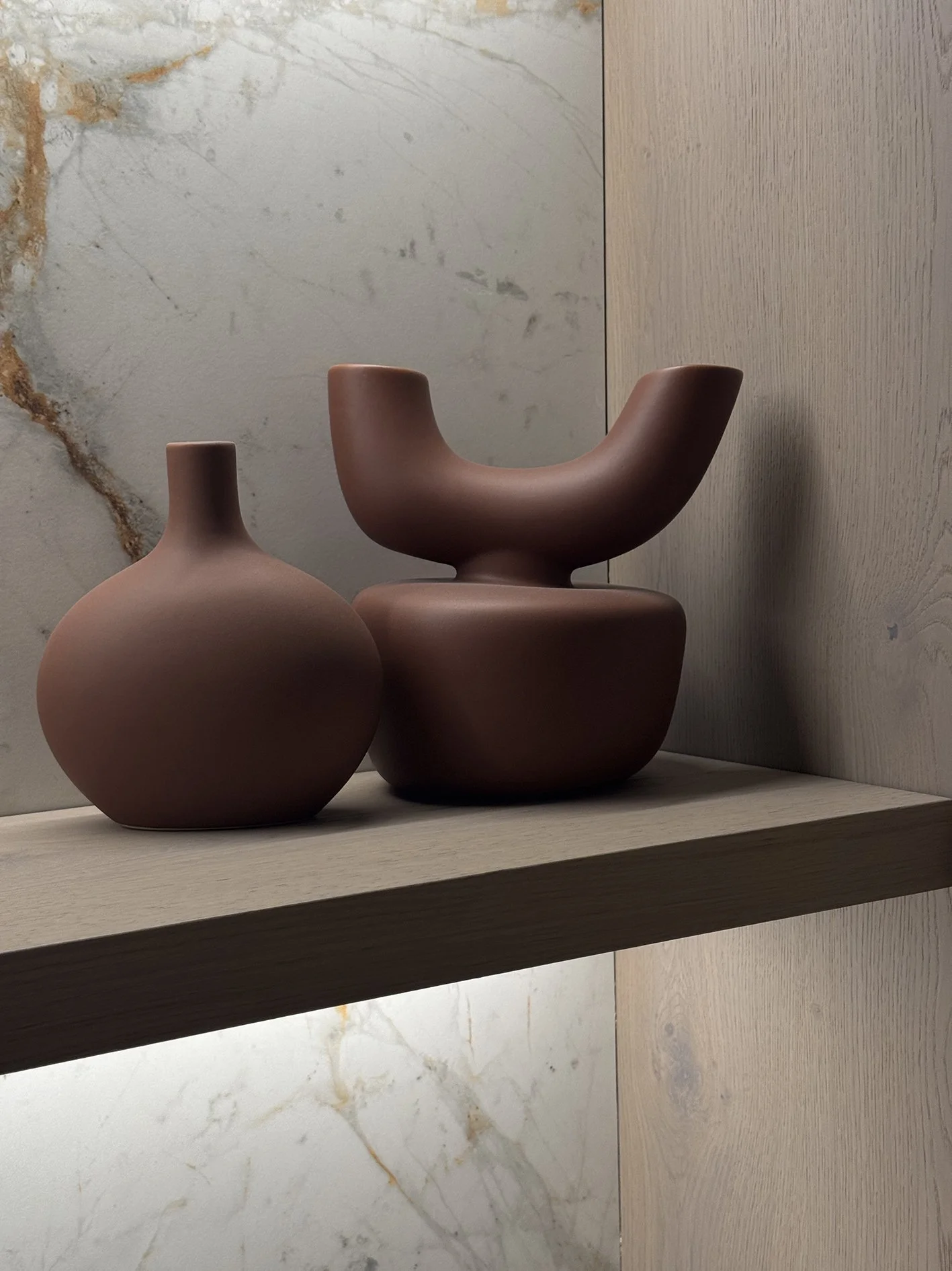 two stylish vessels in  earthy tones made of stone.