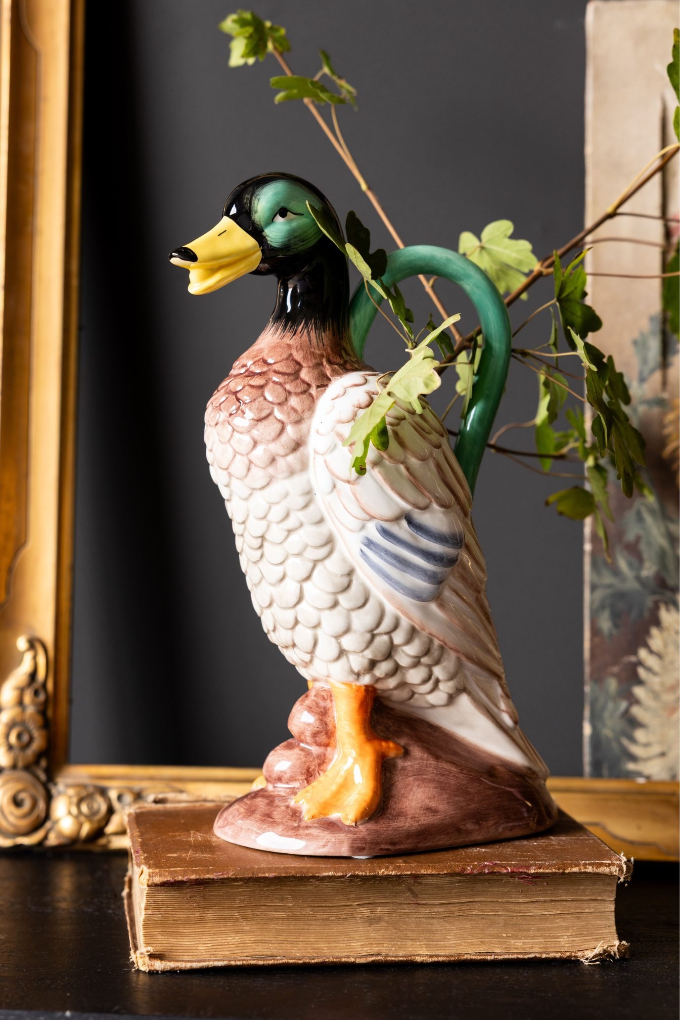 Kitsch male duck-shaped vase with a green head and bright yellow beak.