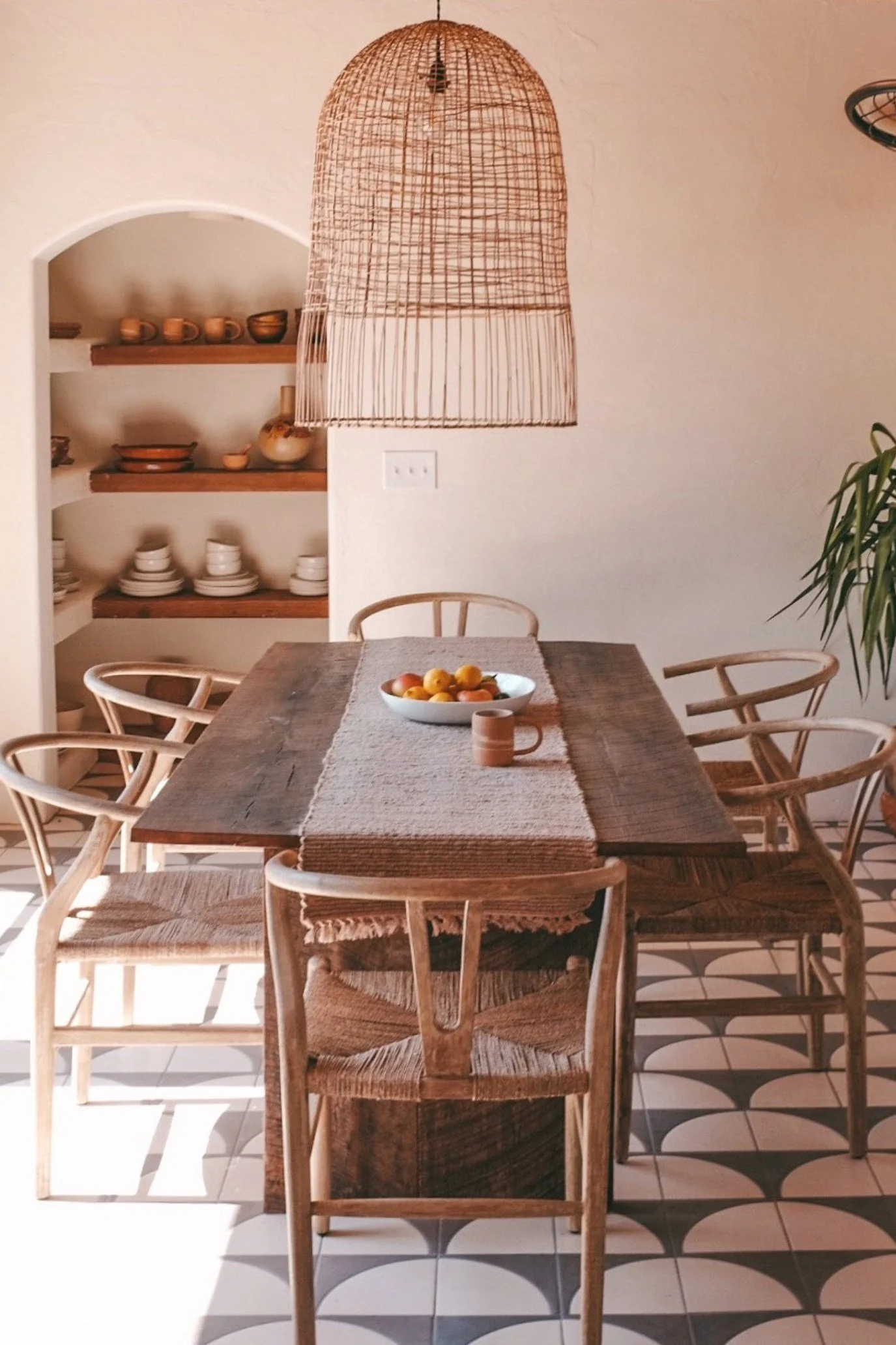 Dining room at JTH Tucson with geometric tiles, Wishbone chairs and oversized rattan pendant