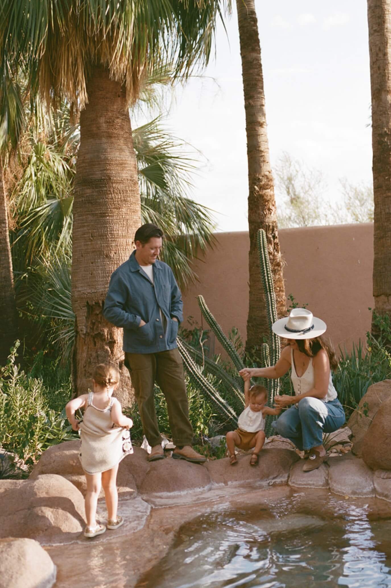 Sara and Rich Comb with daughters at outdoor hot springs at a stylish Tucson vacation rental