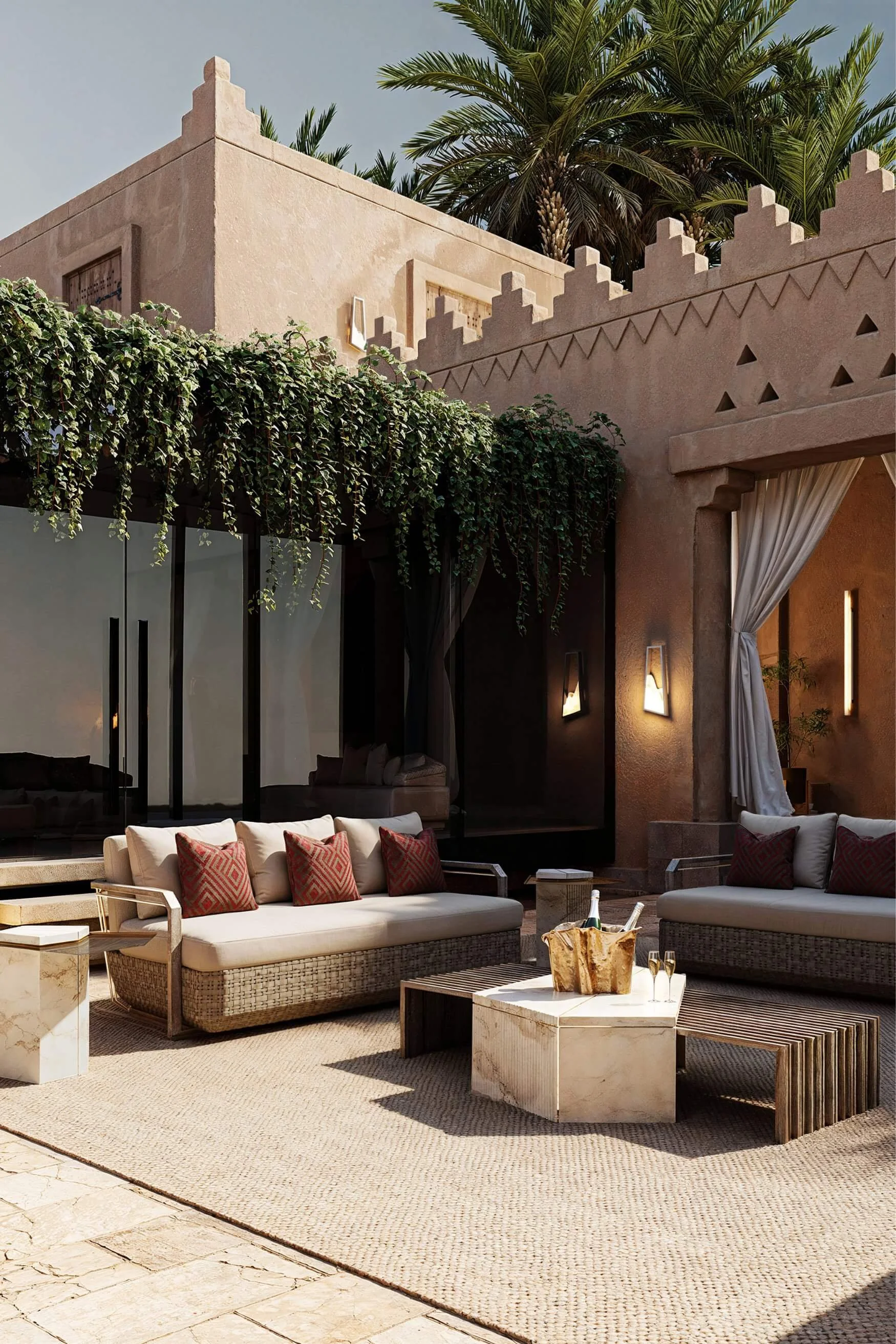 Outdoor courtyard with woven sofas and terracotta patterned cushions in a desert-style setting
