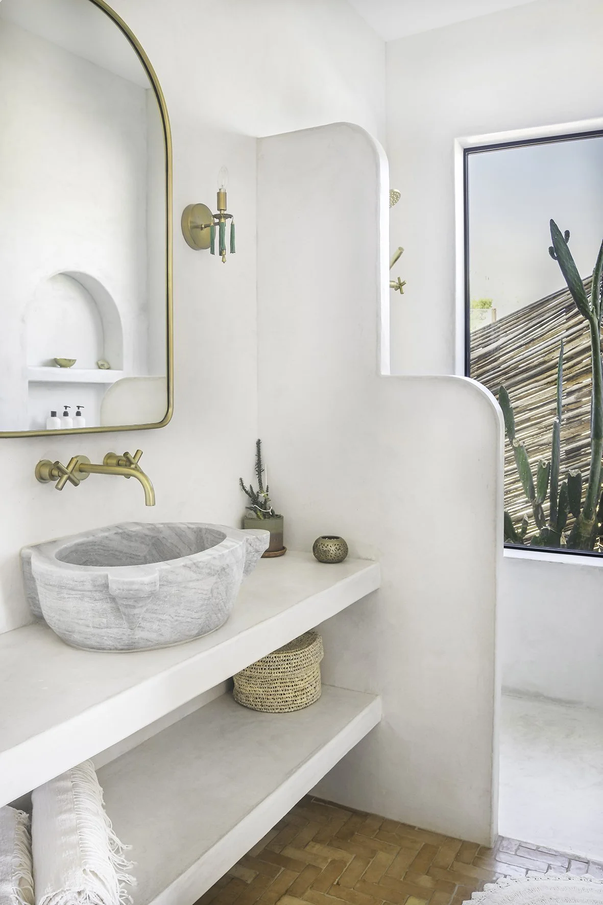 In the master ensuite, a 100-year-old Turkish stone hammam basin sits on plaster shelves above handmade Moroccan terracotta tiles.
