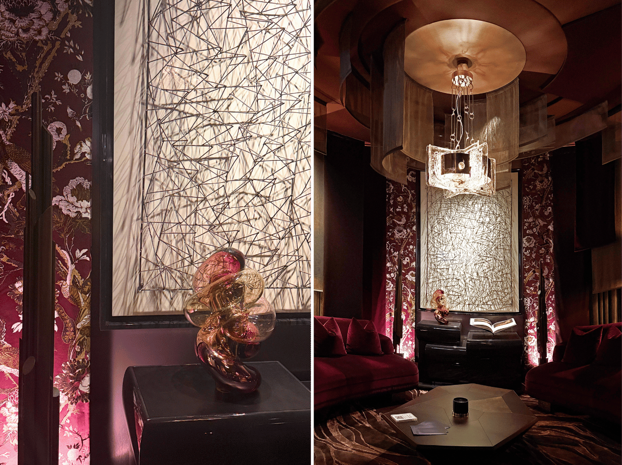 The Parlour by Martin Kemp Design featuring curved sofas, suspended drapery, atmospheric lighting and sculptural artwork.
