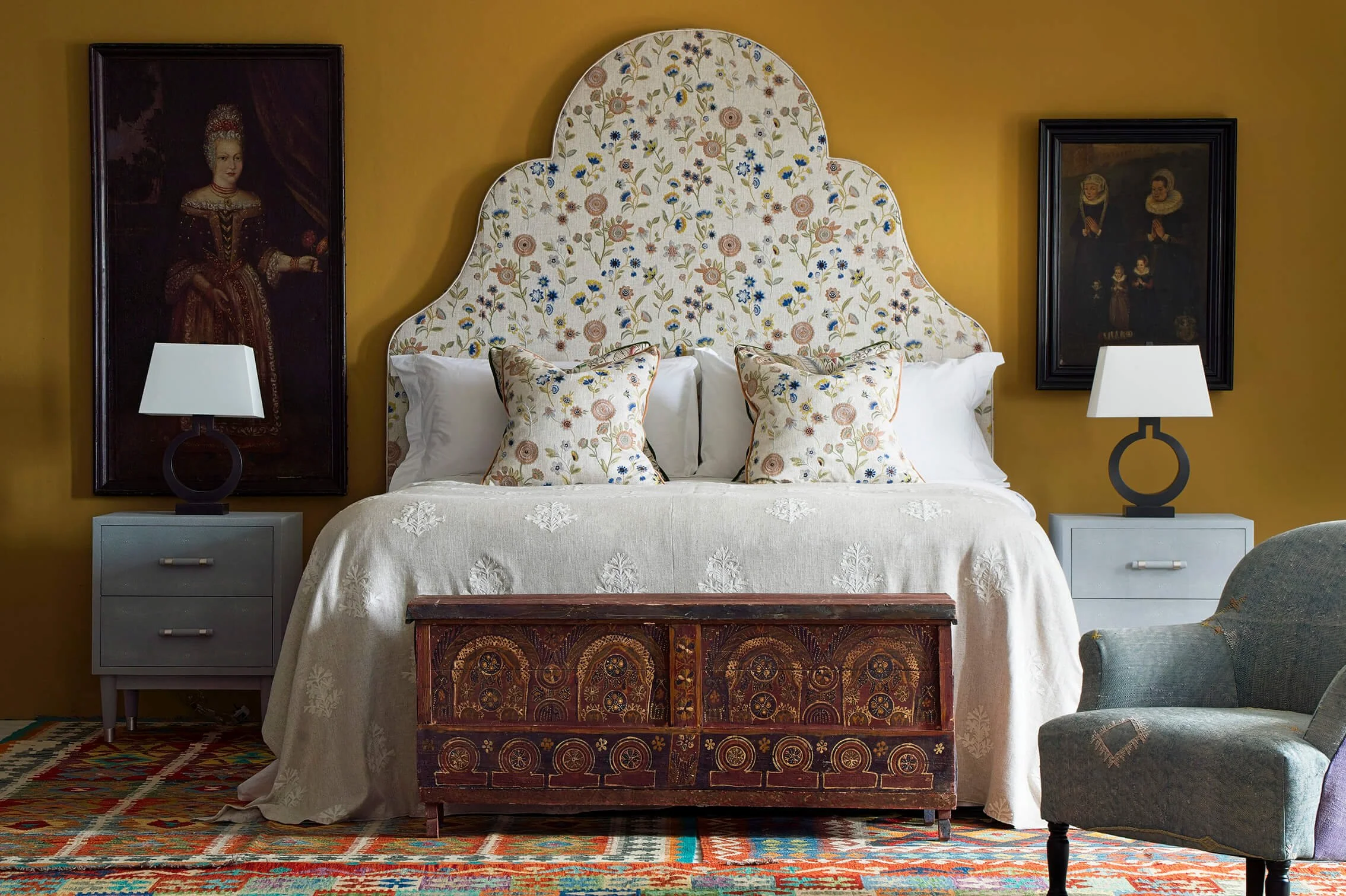 Soft grey upholstered nightstands with black table lamps in an elegant bedroom