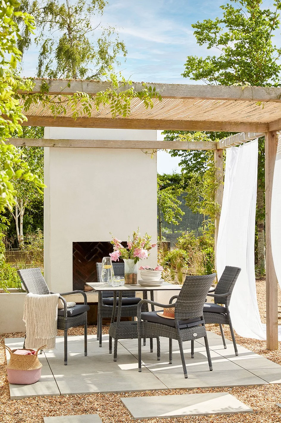 Stylish outdoor pergola with outdoor chimney and white voile curtains