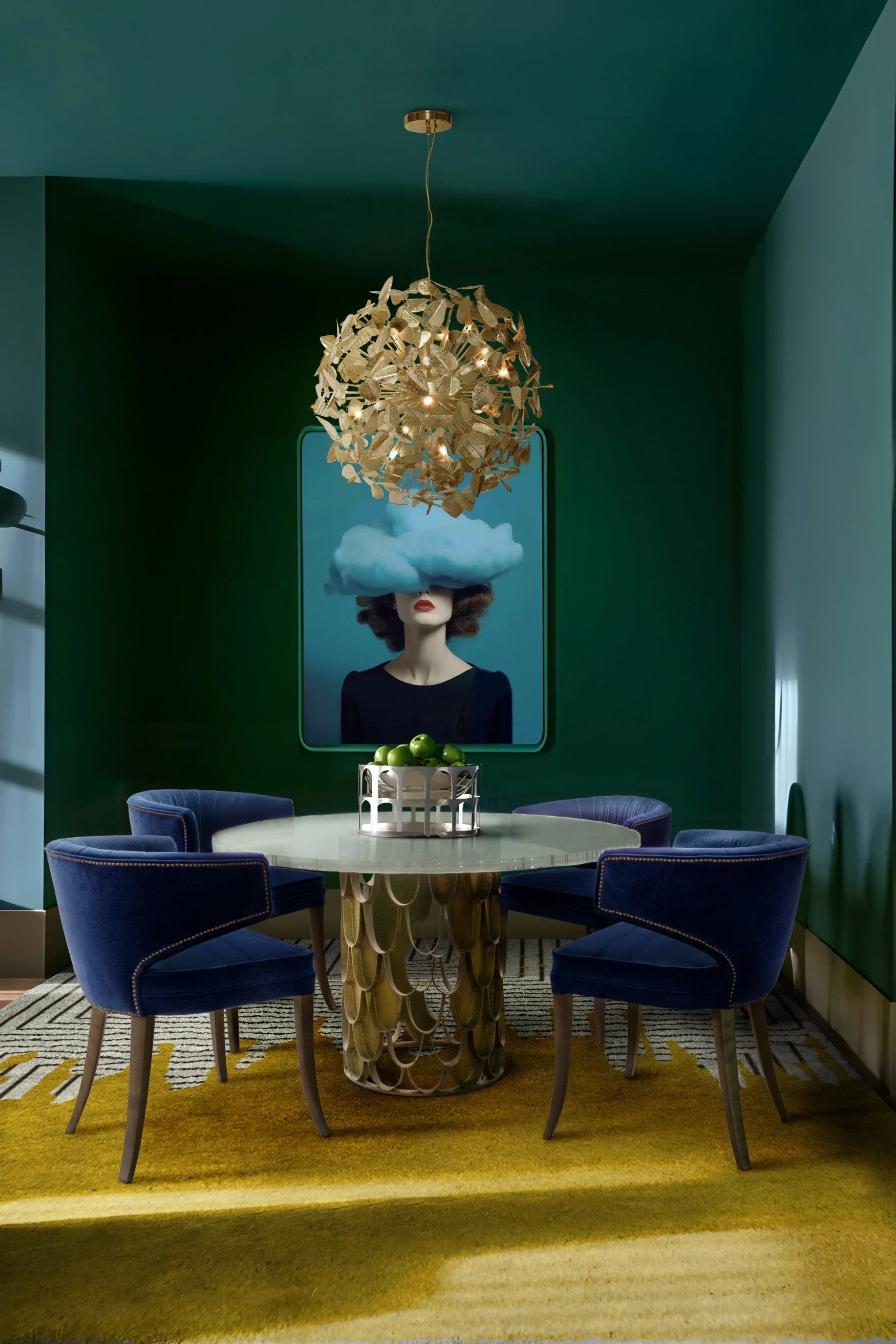 A room painted deep teal with a circular table, blue chairs and a yellow silk rug