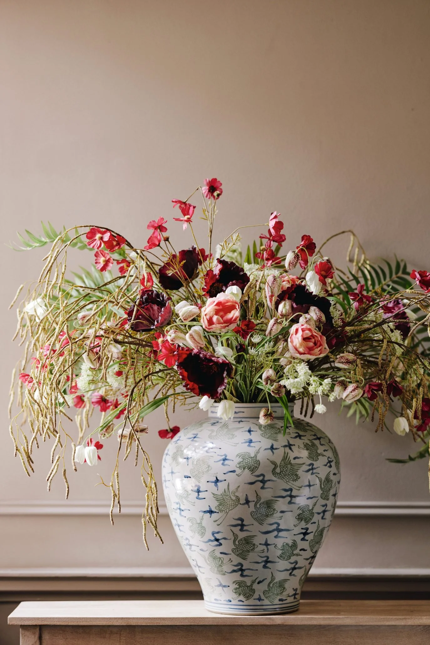 Deep red faux flowers from OKA arranged with foliage as an easy way to introduce a rich red accent.
