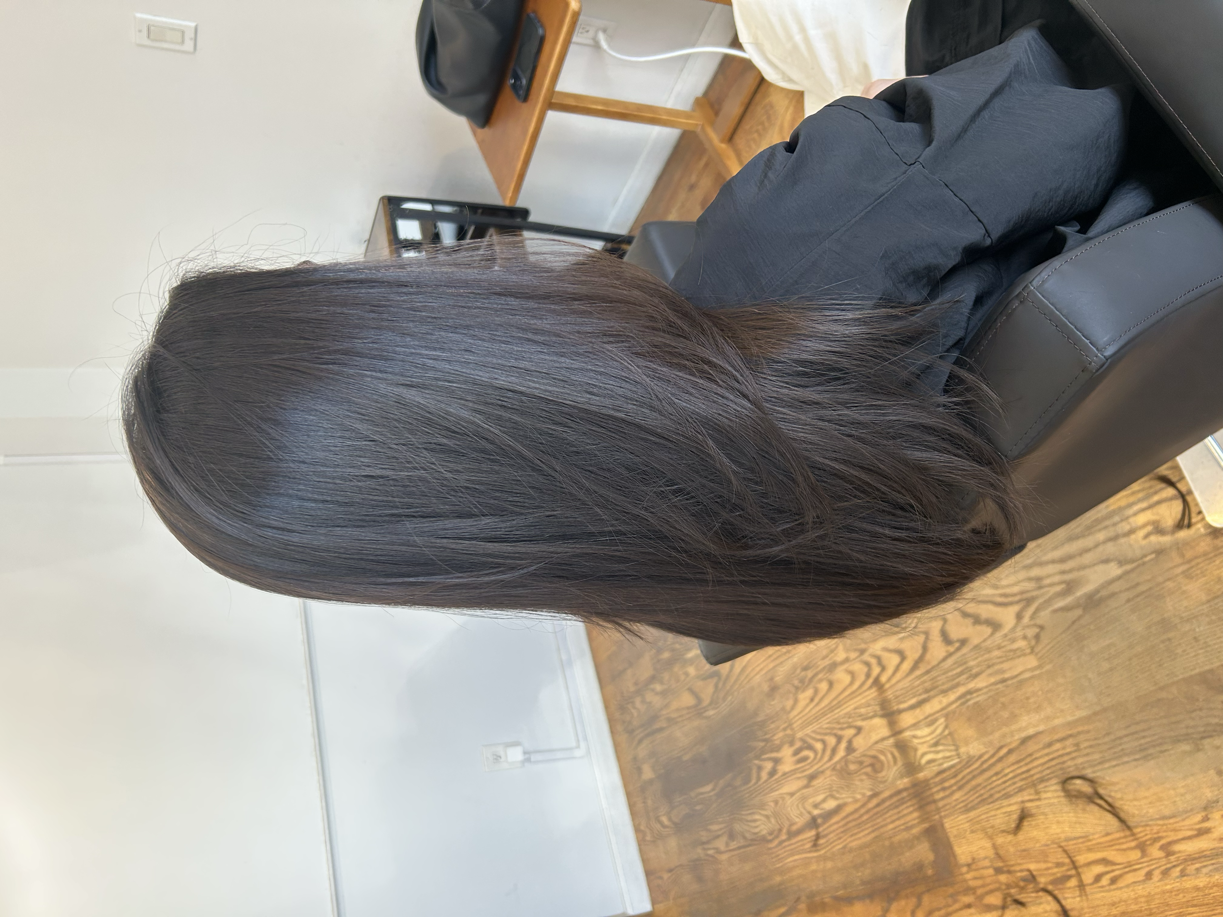 Long dark brown layered haircut with a smooth finish and softly shaped ends at U&K Salon in Brooklyn.