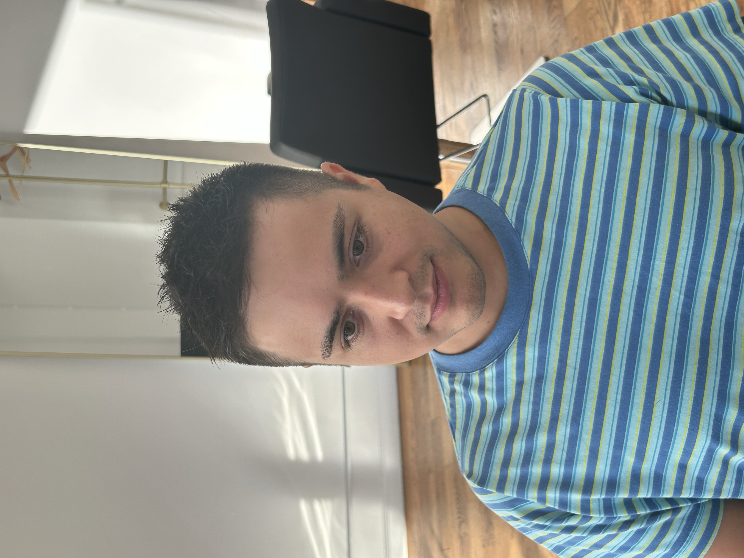 Classic men's short haircut with a neat tapered shape and textured top at U&K Salon in Brooklyn.
