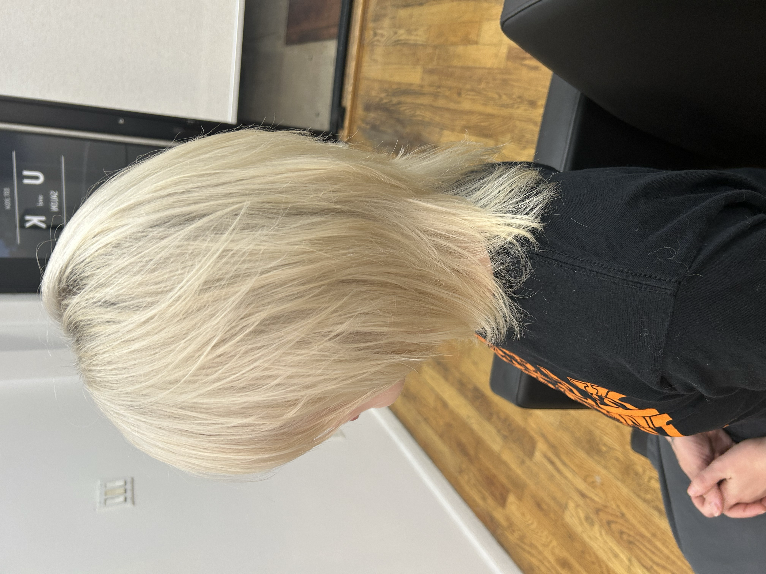 Short layered light blonde hair photographed from the side at U&K Salon in Brooklyn.