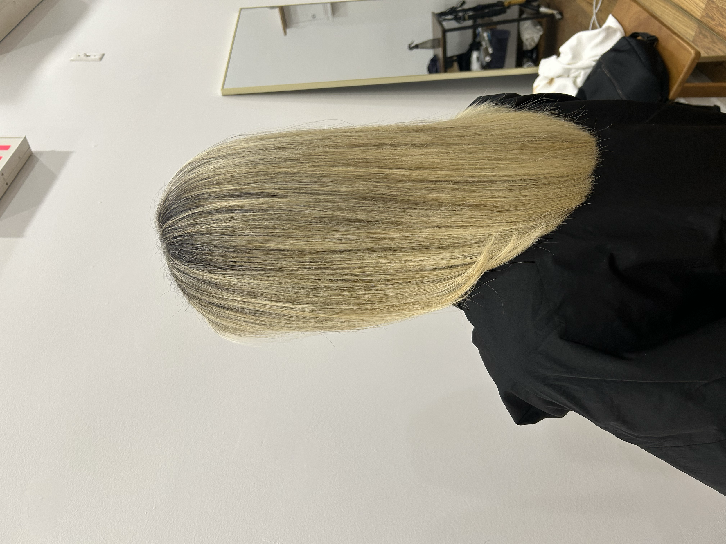 Long straight blonde hair with fine, blended highlights and a natural-looking finish at U&K Salon in Brooklyn.